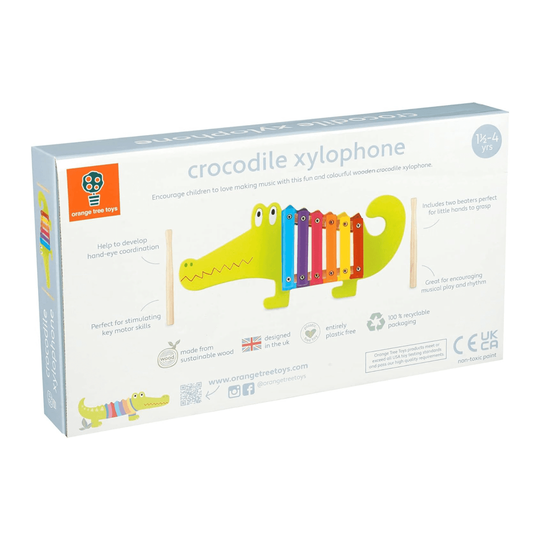 back view of crocodile xylophone packaging featuring benefits and features including great for encouraging musical play and rhythm - designed in the uk and made from sustainable wood