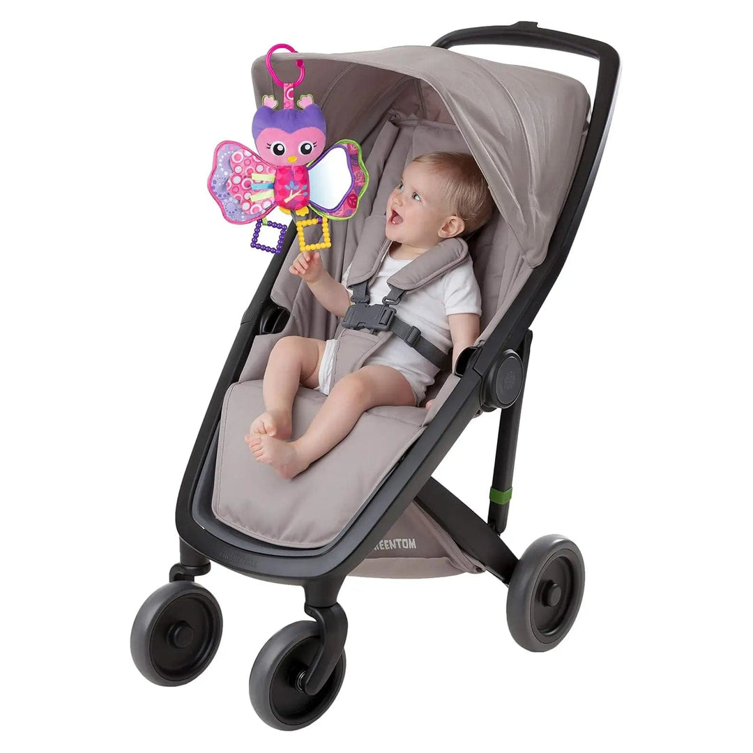 Baby in a buggy looking at Hooty Owl activity toy hanging from the stroller