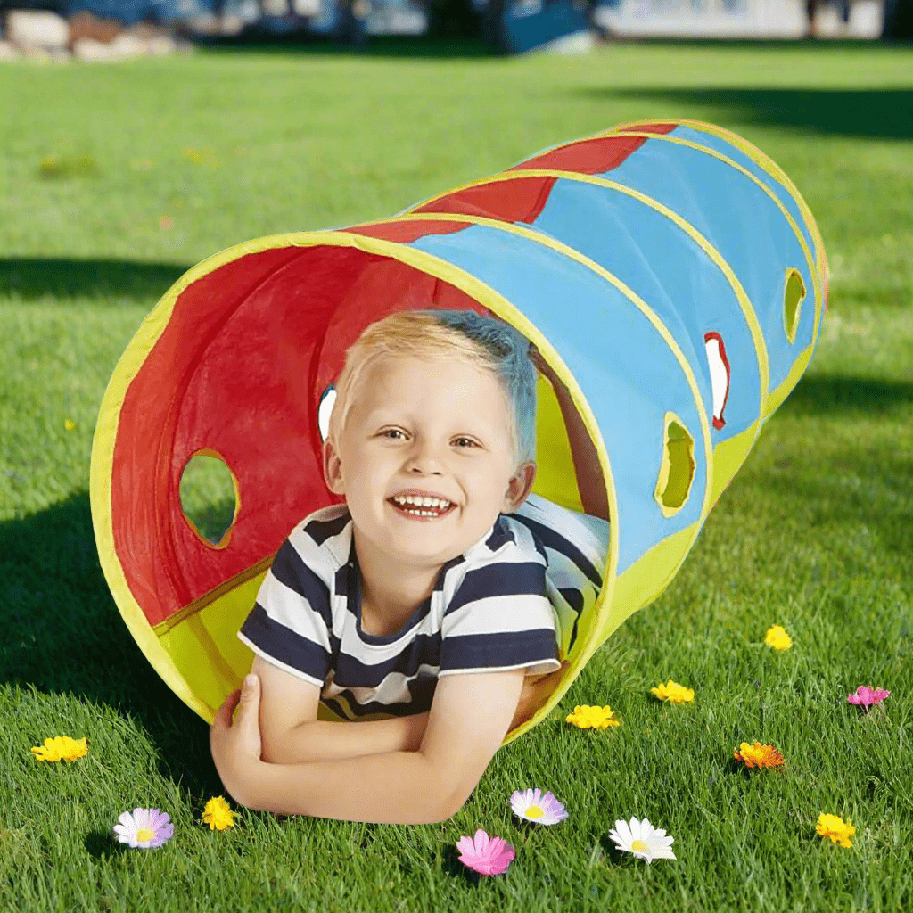 Boy lying inside a pop up play tunnel in bright colours for indoors and out in the garden