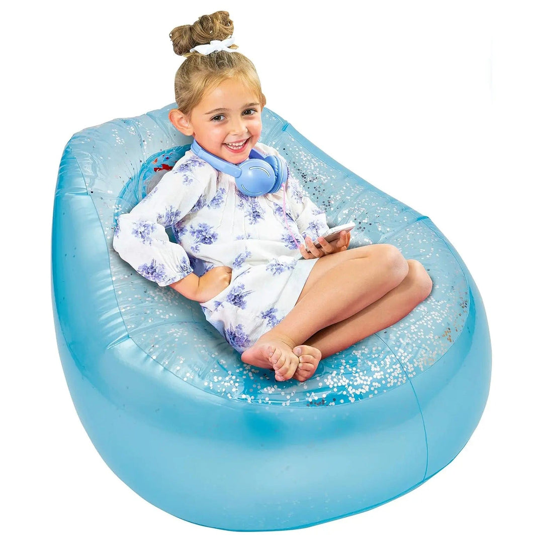 Young girl with headphones sitting on Kids Disney Frozen blue inflatable glitter chill chair