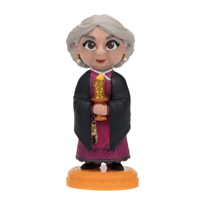 mini abuela figurine holding a gold candle