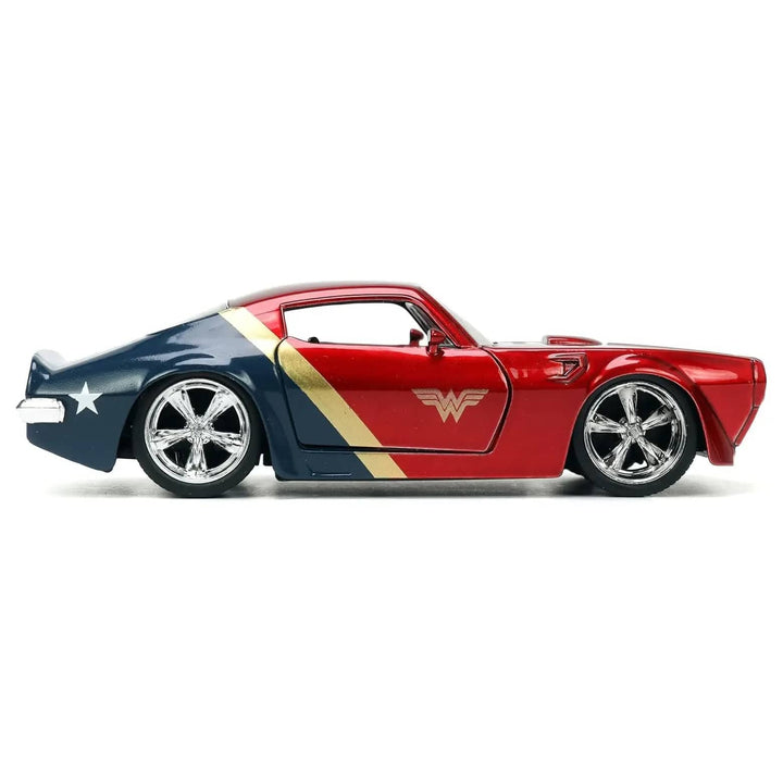 Side view of a die-cast metal blue, gold and red pontiac firebird with Wonder Woman logo on the door