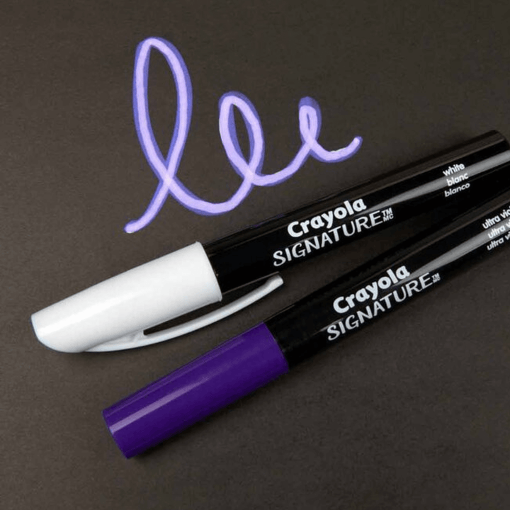 purple and white markers on dark coloured paper with purple neon doodle drawn to highlight light neon effect