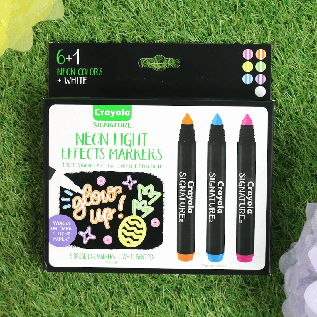 crayola neon light effects markers on grass with colourful decorations