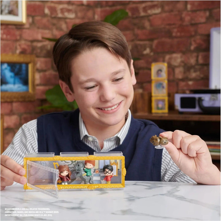 Boy playing a pack of 4 Harry Potter micro magical moments figures