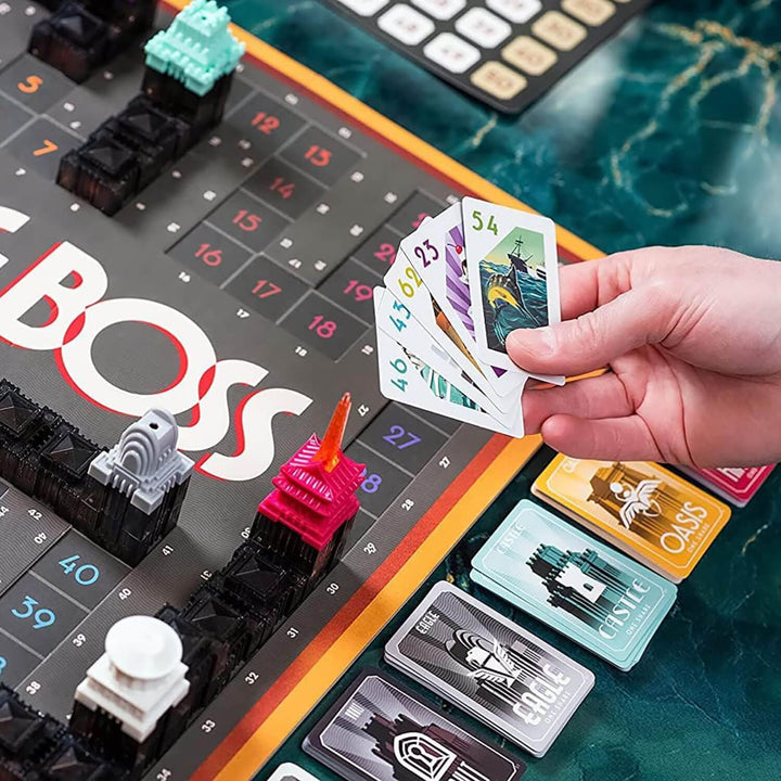 Board game with cards in a hand and player tokens,.