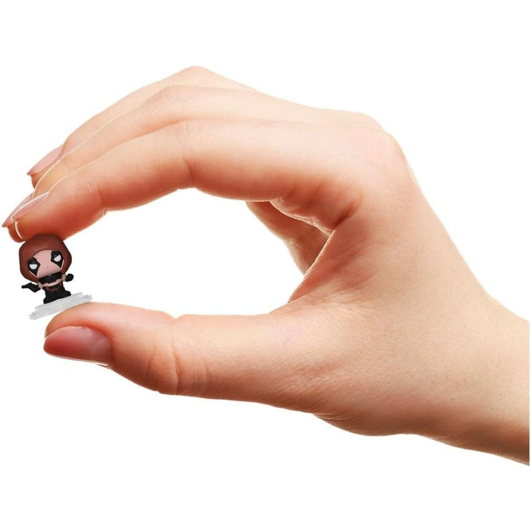 Hand holding a small Gi Joe figurine against a white background