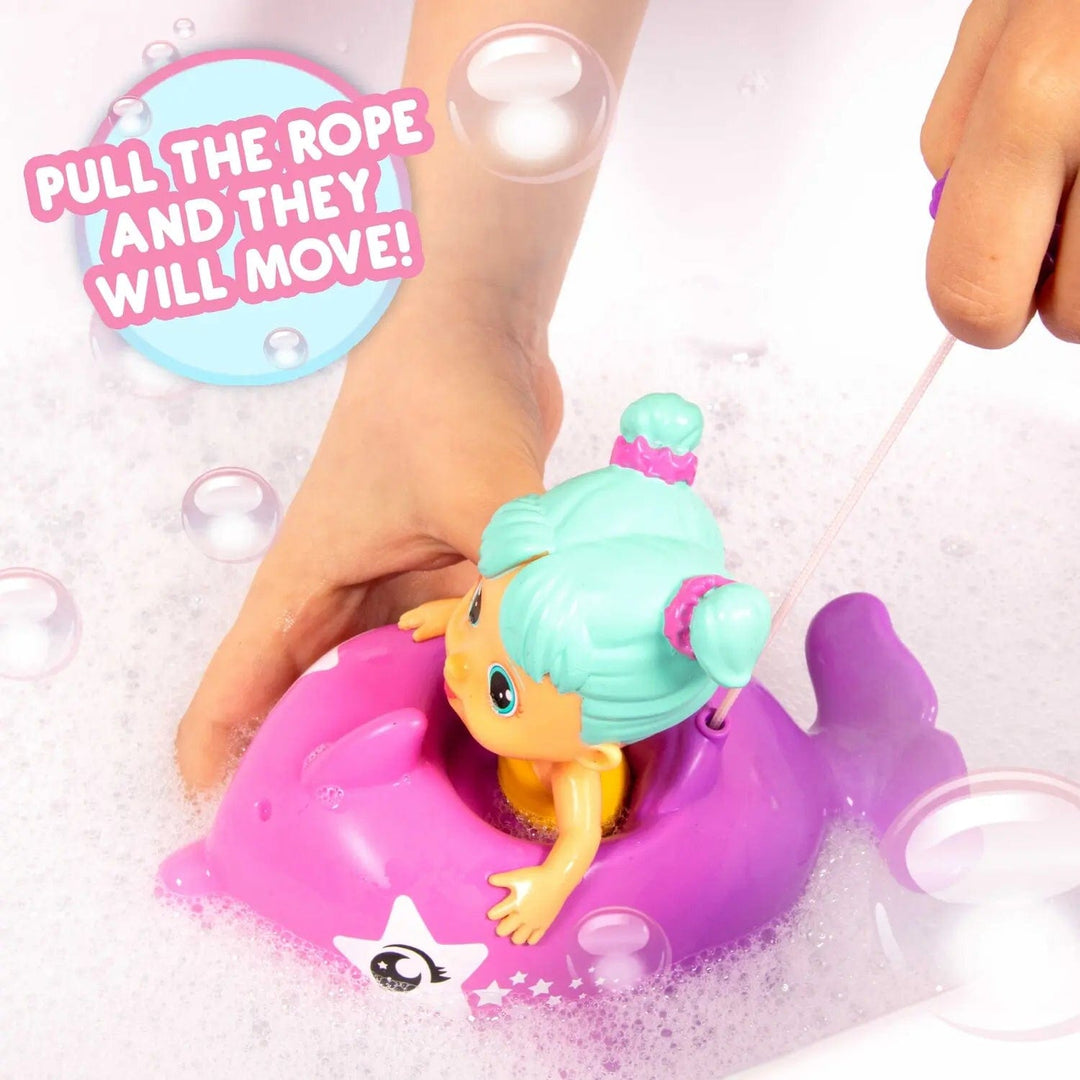 Bloopies Floaties Dolphin bath toy in the bath with bubbles and hands pulling the string