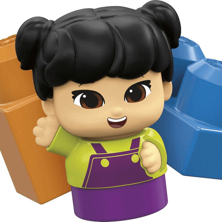 close up shot of blue and brown coloured mega bloks brick with raphy block buddies figure wearing green and purple overalls