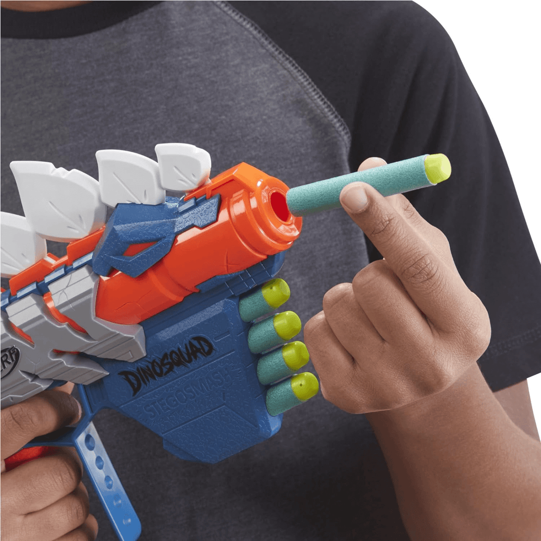 young boy loading dart into gun with 4 darts already in storage slots