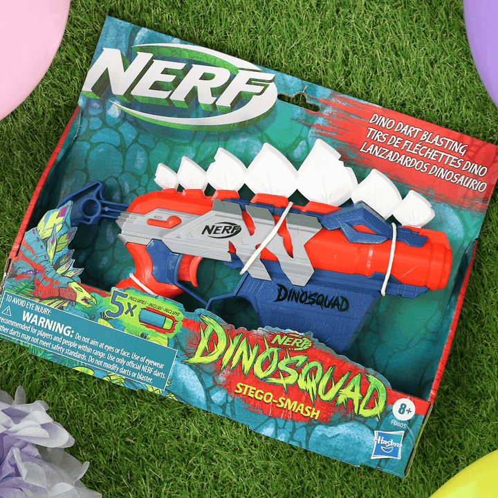 nerf dinosquad on grass with coloured balloons to the side