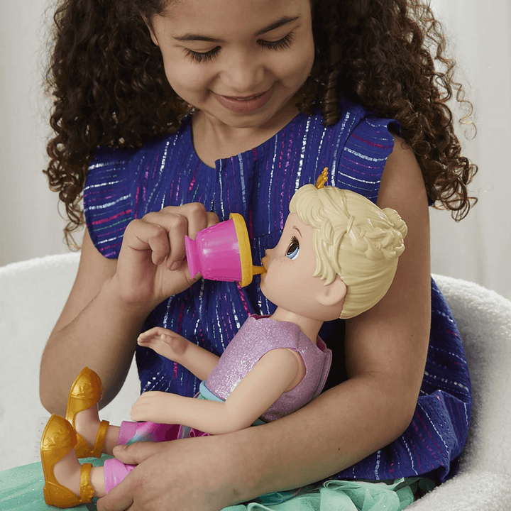 young girl feeds princess ellie doll with her pink and gold sippy cup