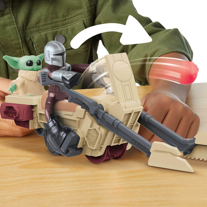Toy figure of a character from a popular franchise with a weapon, held by a person wearing a green shirt.