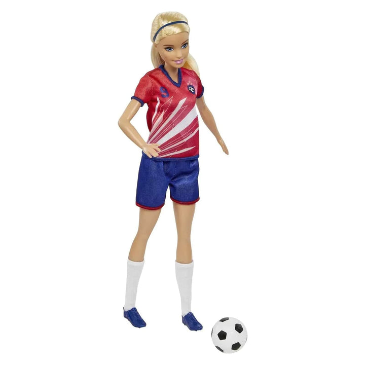 Barbie football player in red jersey and blue shorts, with black and white match football