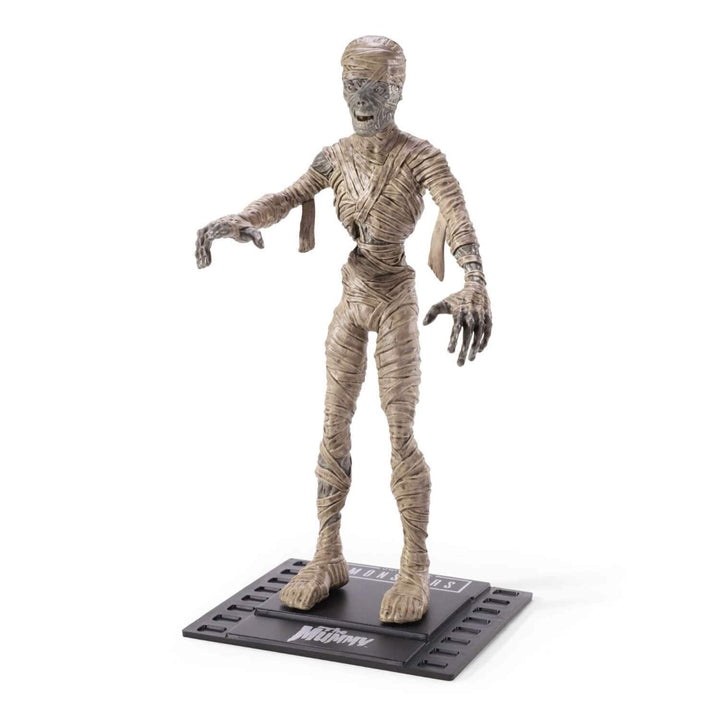 A Mummy action figure standing on a black display base with the title &