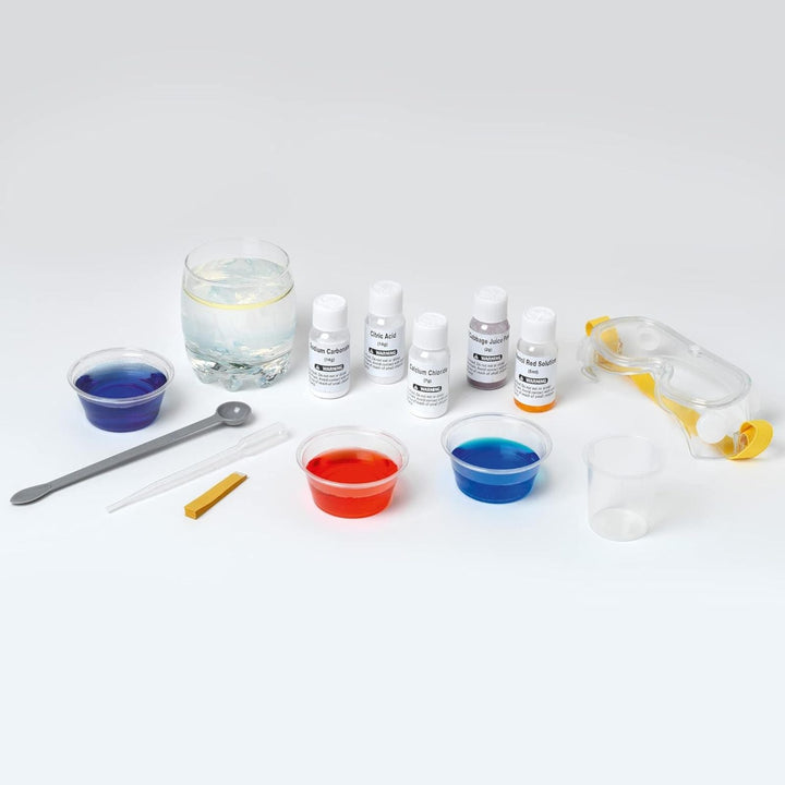 Science experiment kit with beakers, bottles, and tools on a white background