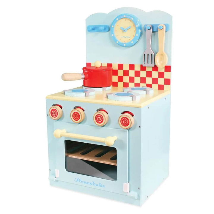 Toy kitchen set with oven, stove, and utensils on a white background