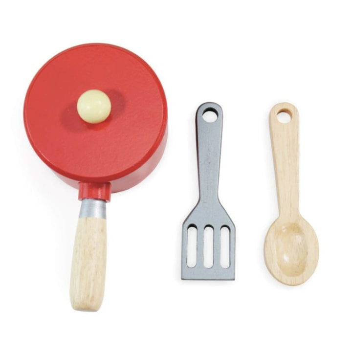 Set of wooden toy kitchen utensils including a red frying pan, spatula, and spoon on a white background