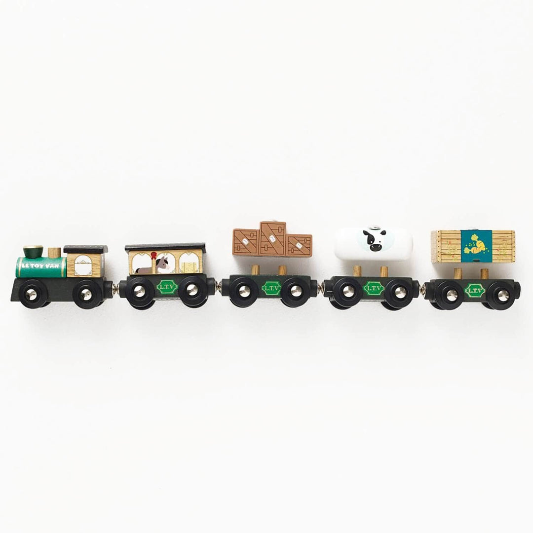 Farmyard theme green toy train set on a white background
