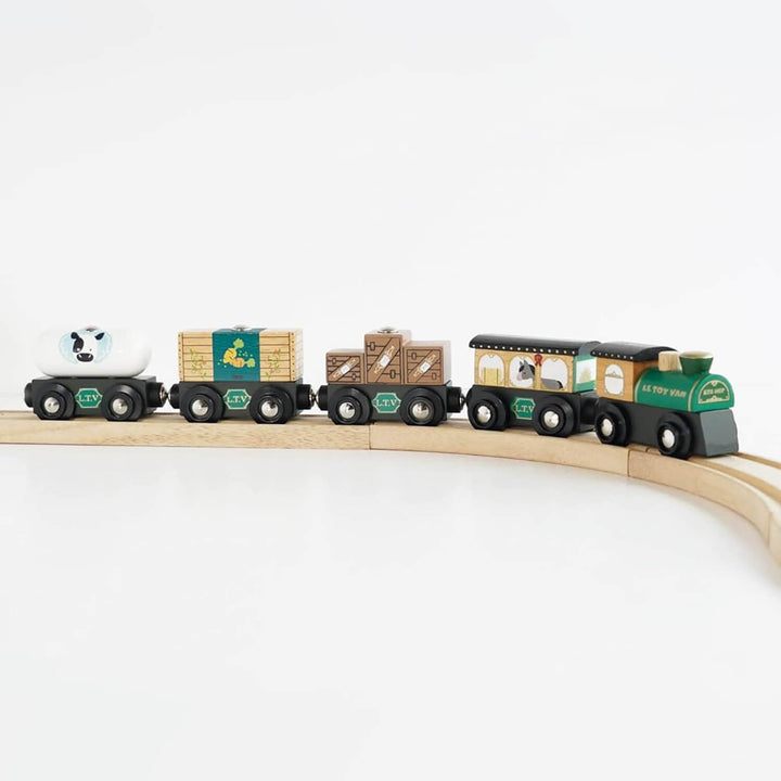 Green wooden toy train set on a white background
