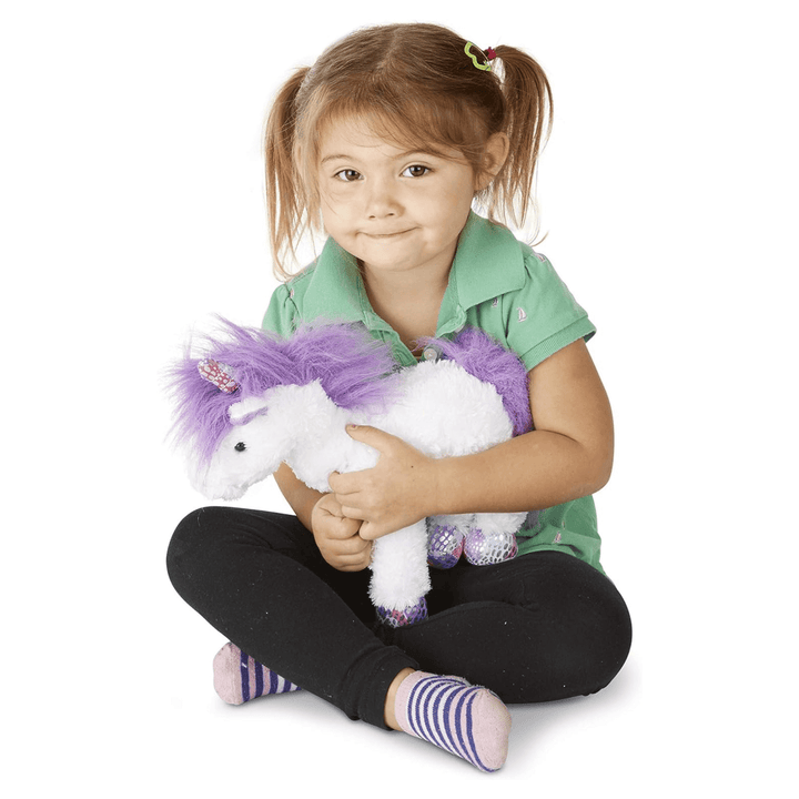 little girl hugging misty unicorn