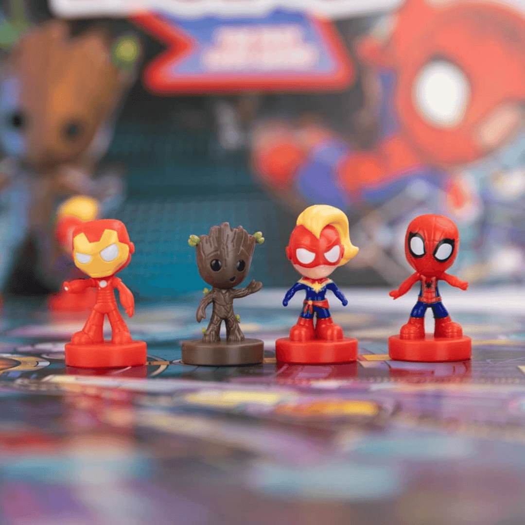 detail shot of playing pieces on board including iron man and groot