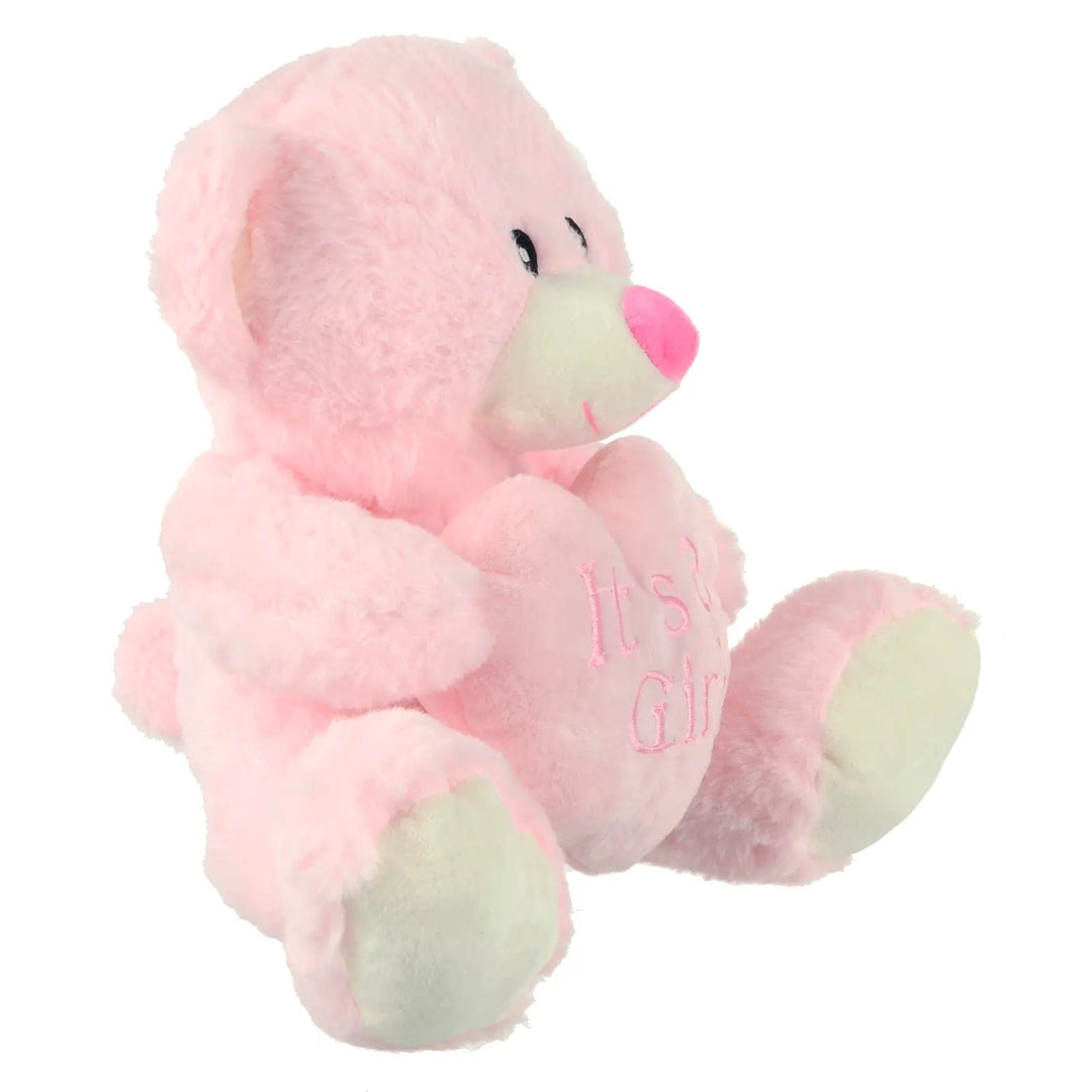 Side view of baby pink teddy bear holding a pink heart