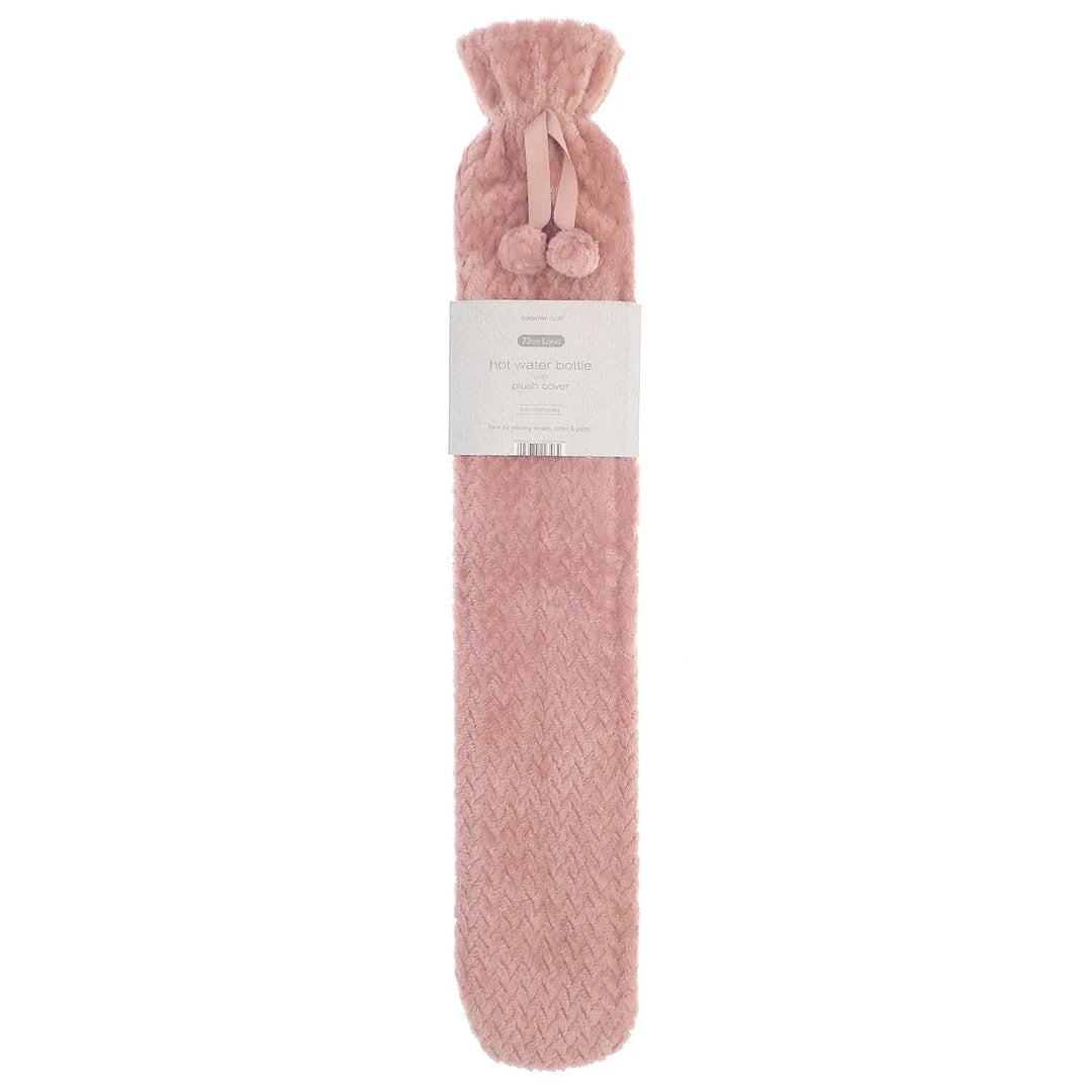 Long hot water bottle with blush pink fleece cover and pom poms