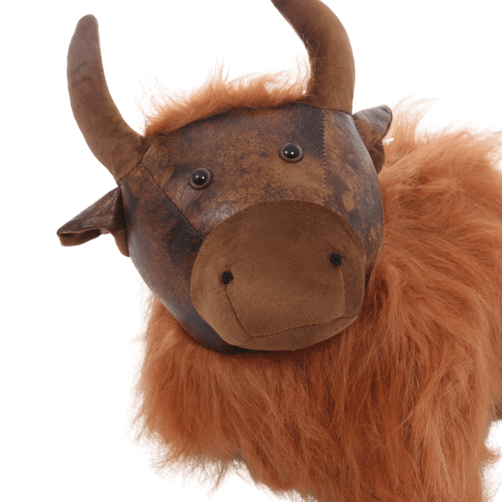 detail shot of highland cow face with beaded eyes, plush horns, nose and faux leather face