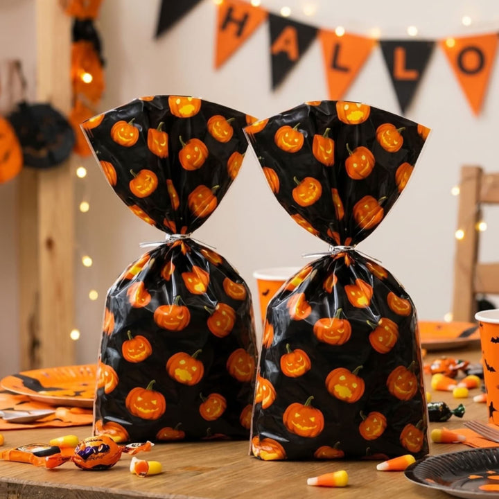 Two black Halloween party favor bags with an orange jack-o&