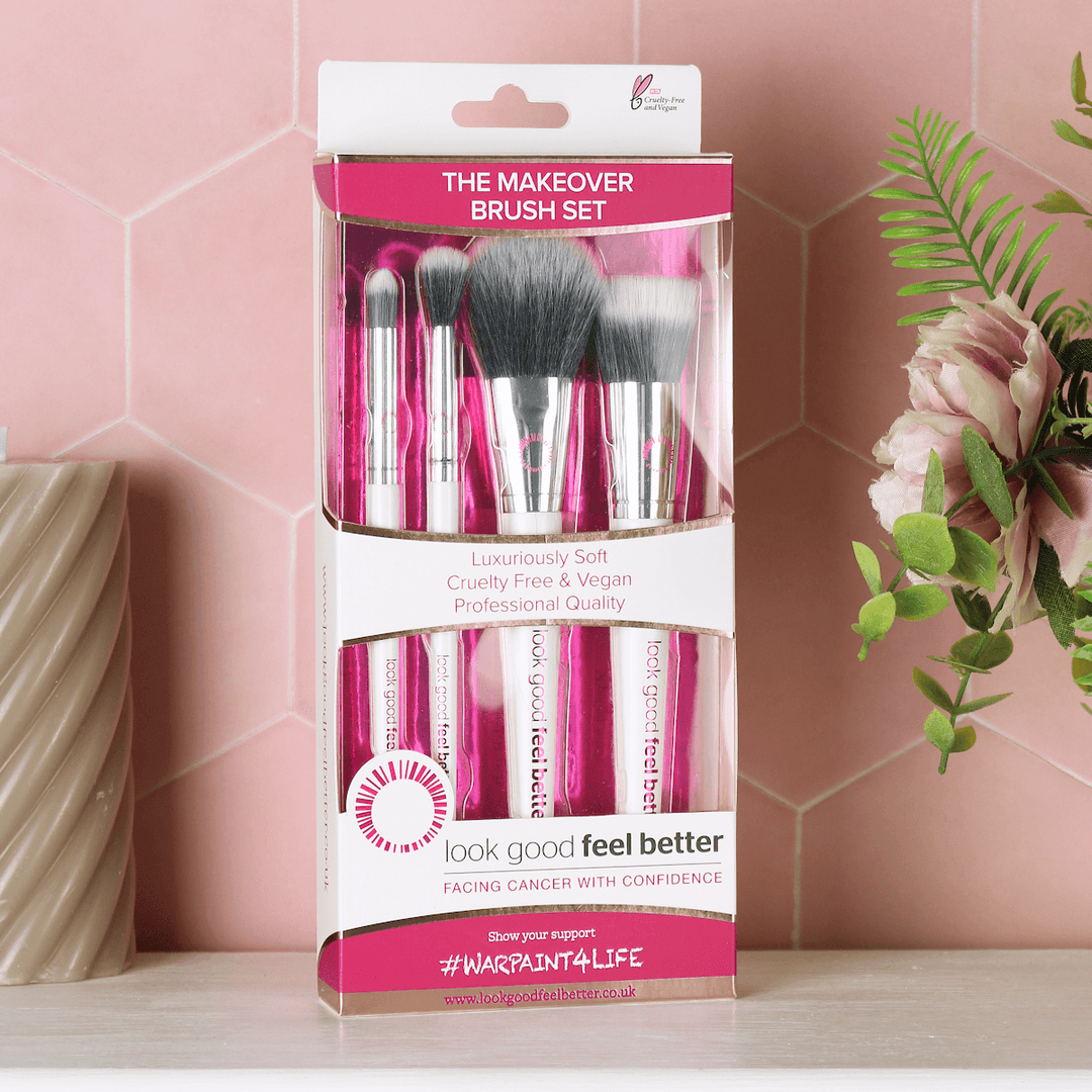 makeover brush set box on bathroom counter beside candle and flowers