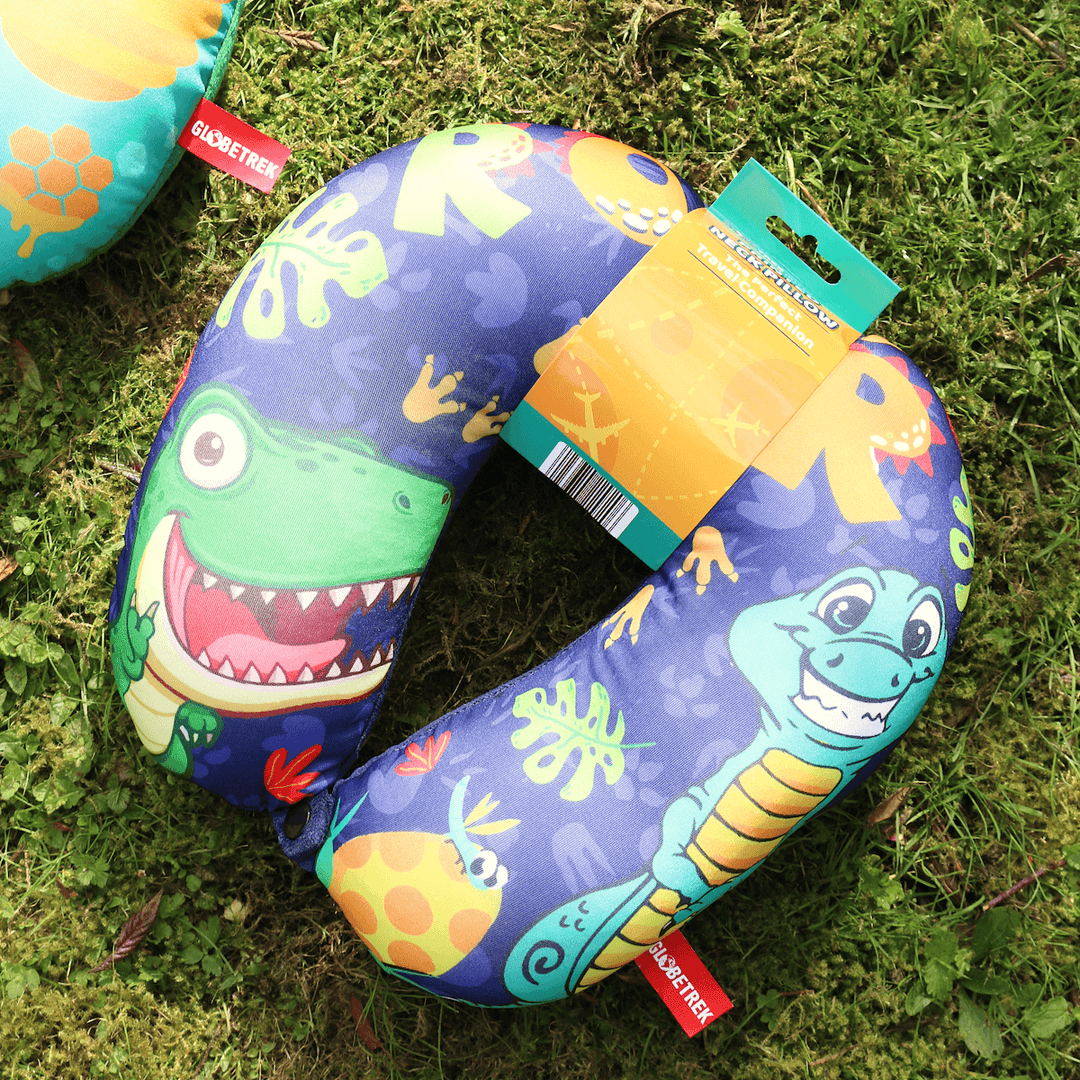 dinosaur pattern neck pillow in packaging on grass outdoors