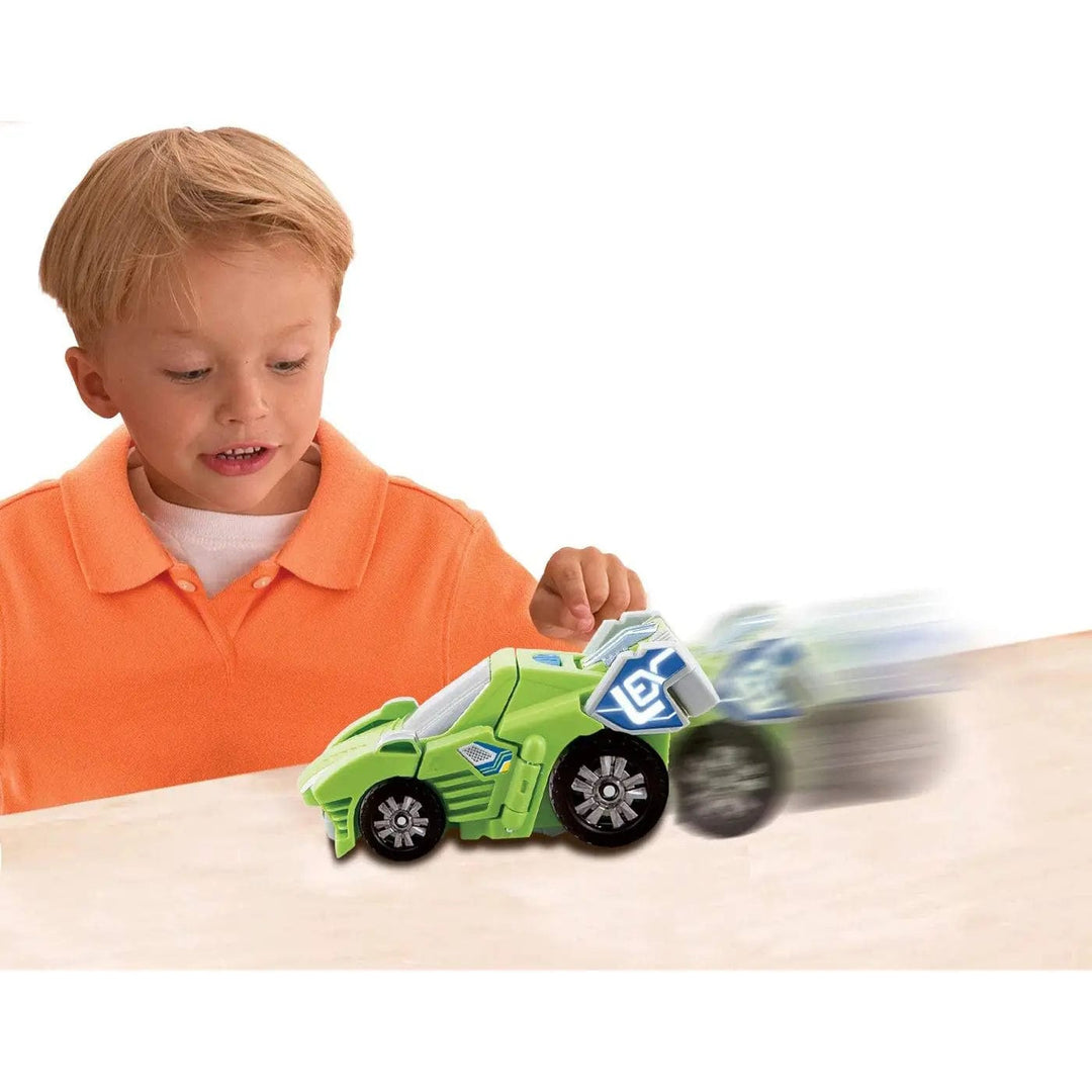 Boy playing with a green Switch & Go Dino car