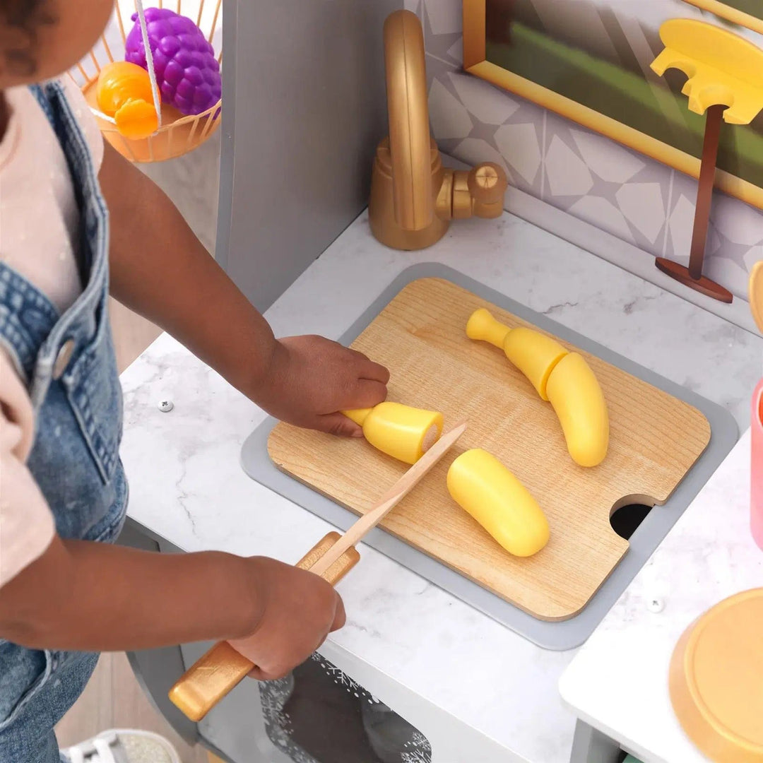 pretend banana on chopping board over the sink of play kitchen