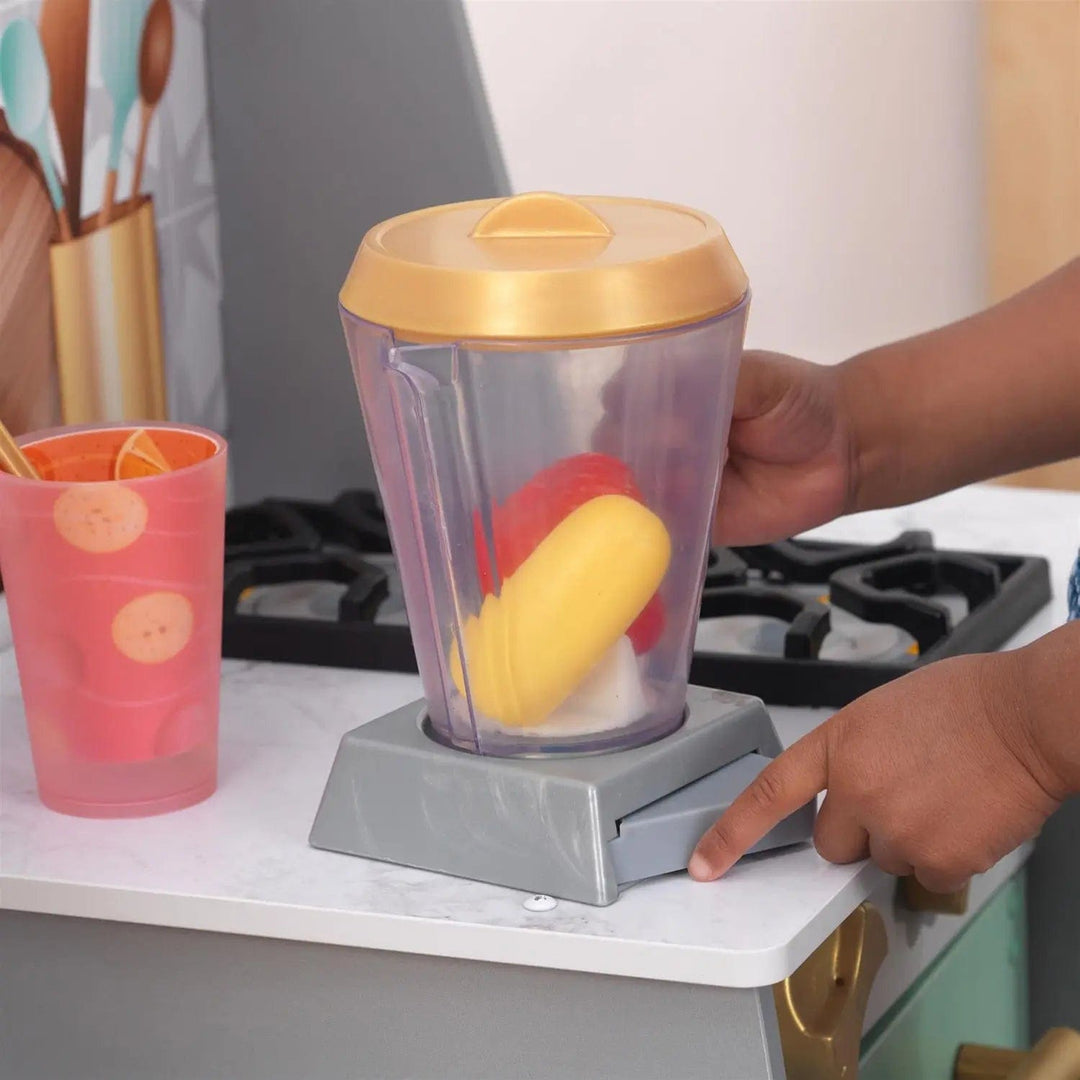 Pretend fruit in a play blender in a wooden toy kitchen