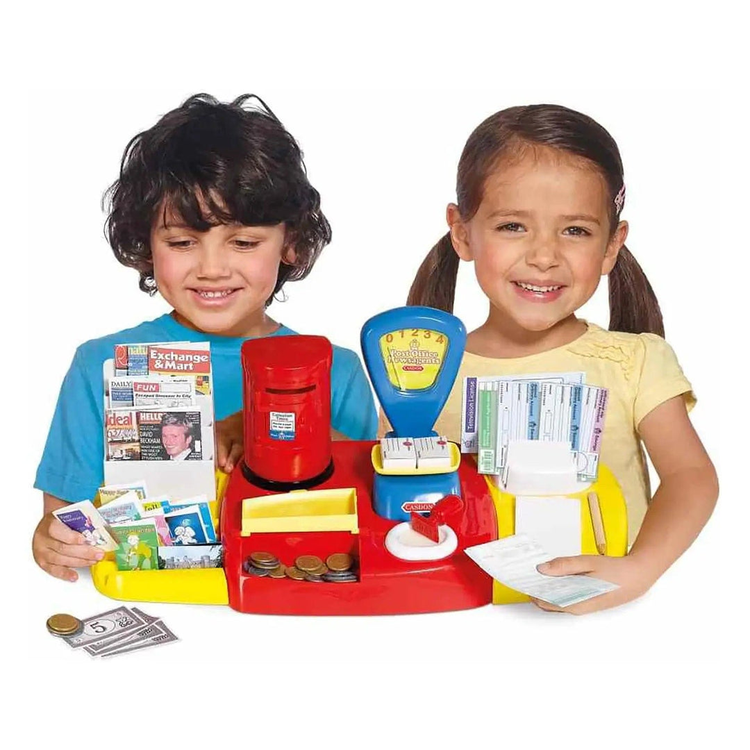 2 children playing with a Post Office playset that has a red post box, money, cards and magazines