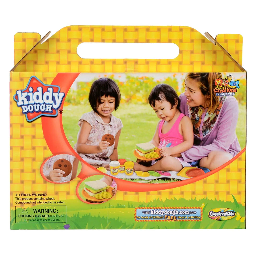 Back of the pack of Kiddy Dough Picnic Basket play set with mum and 2 kids playing out in the garden