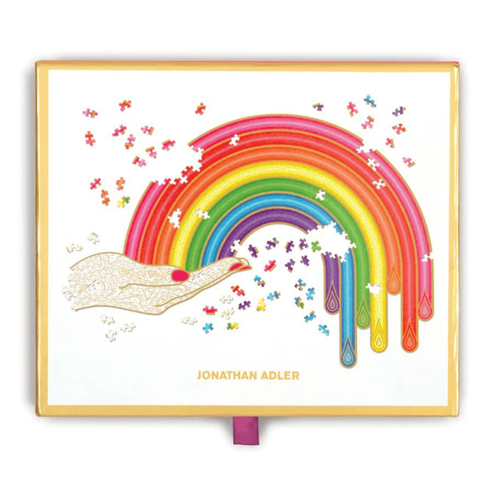 Jonathan Adler Rainbow Hand Shaped Jigsaw Puzzle Storage Box with Gold Foil edges and red ribbon drawer pull tab