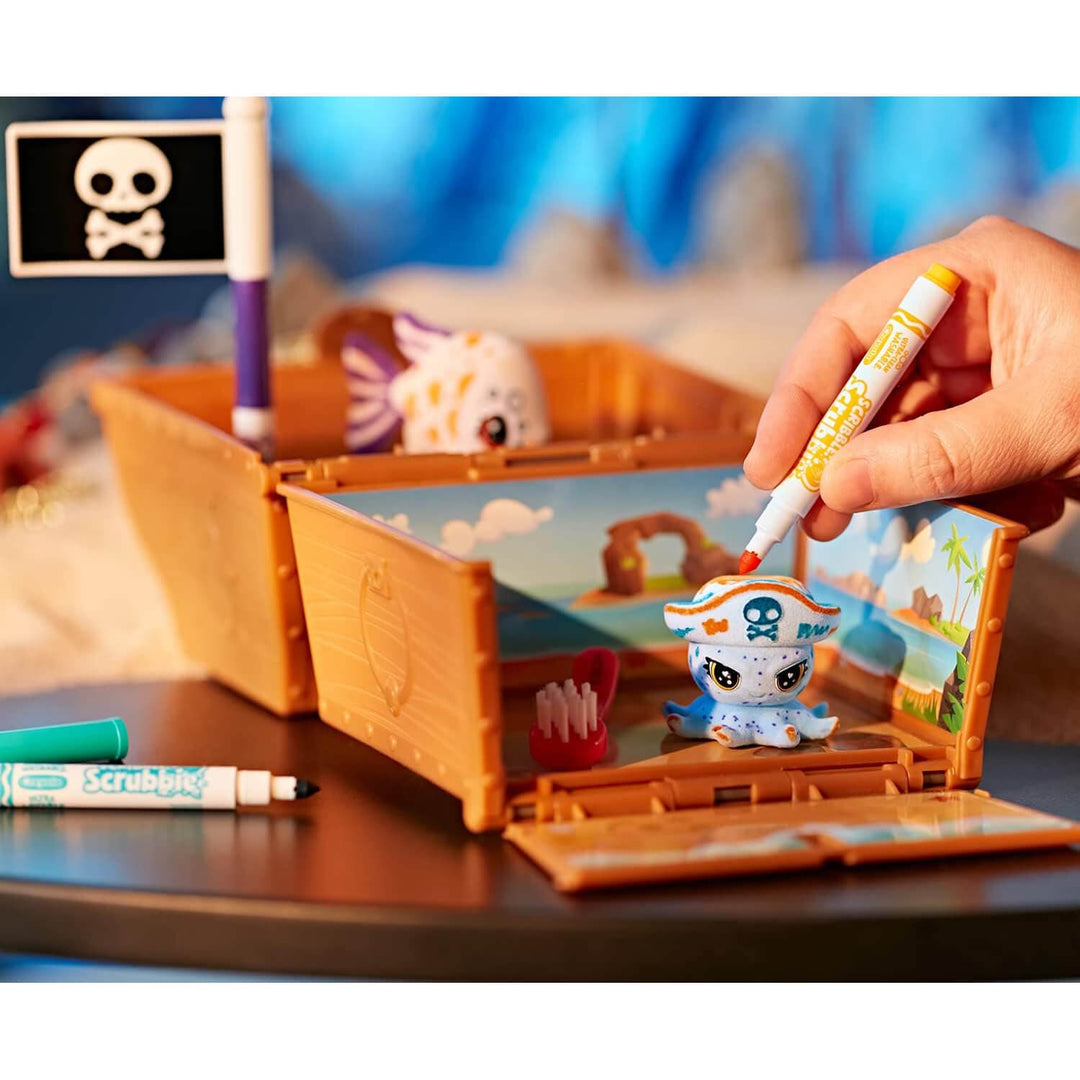 Toy pirate chest with figurines and markers on a table