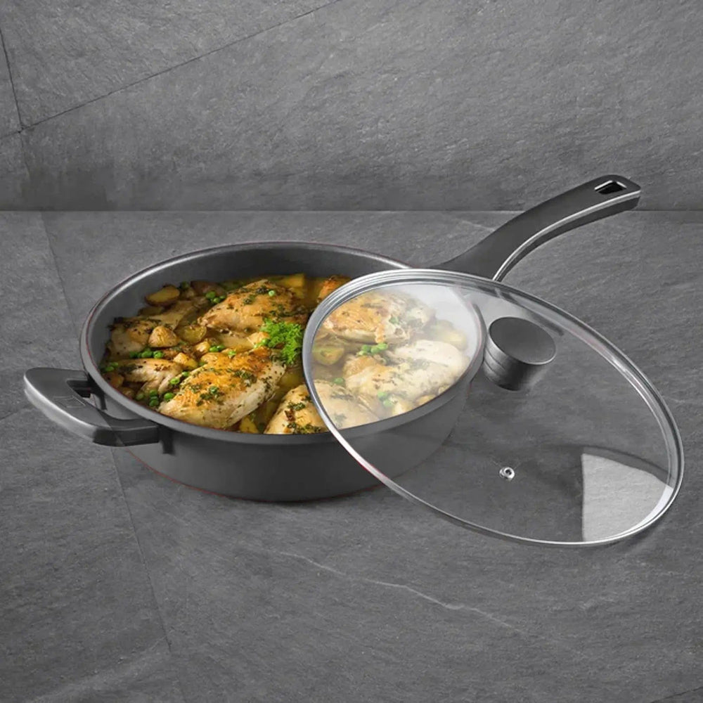 large black frying pan with lid, filled with chicken and vegetables for one pan meals