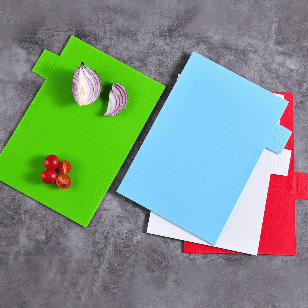 4 boards outside of chopping board holder with diced vegetables on top