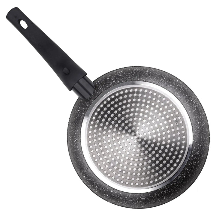 Dot induction base of a black marble effect coated frying pan