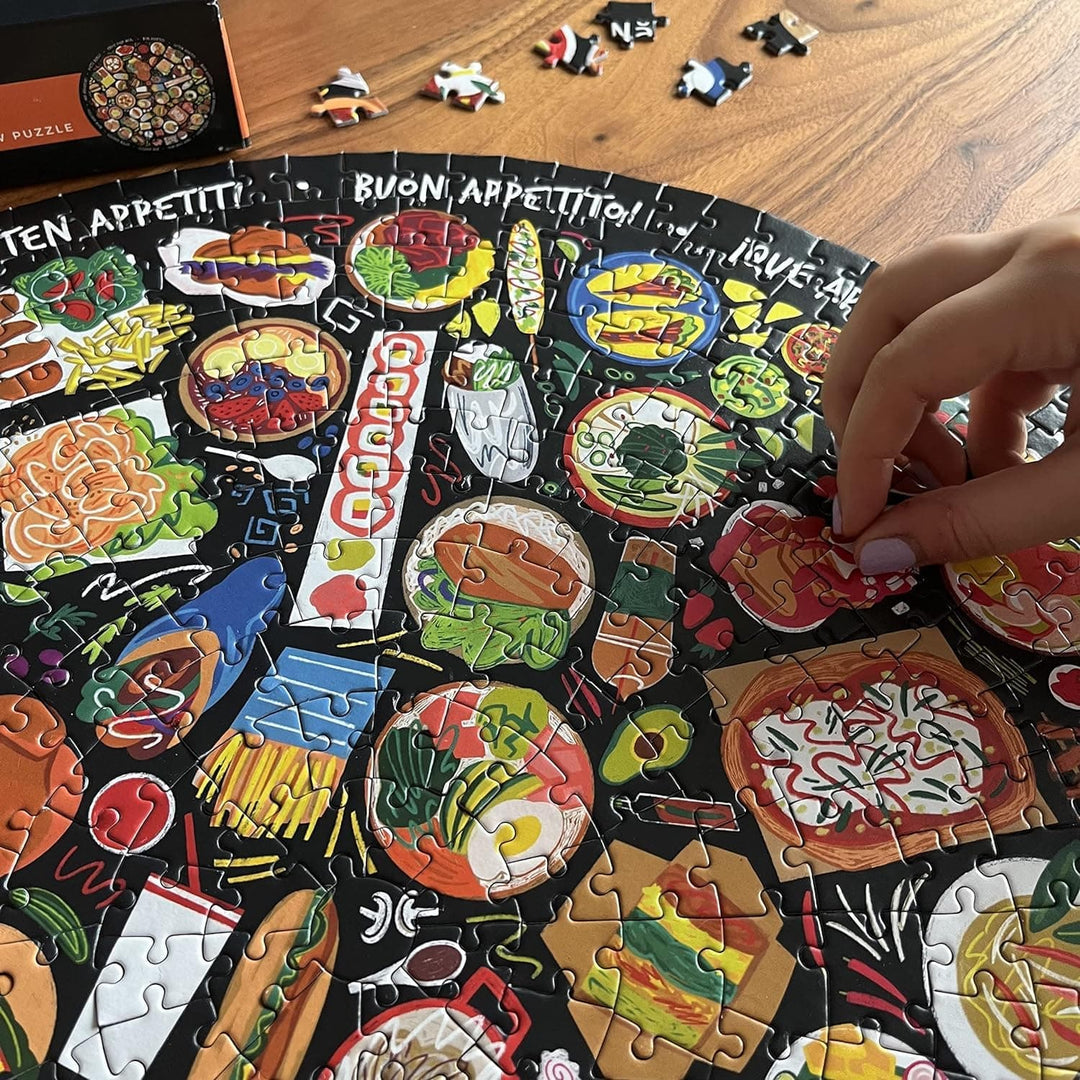 Close up of a person inserting the last piece into a World Food jigsaw puzzle