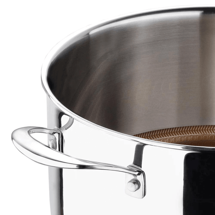 detail shot of polished silver stainless steel stock pot exterior with side handle