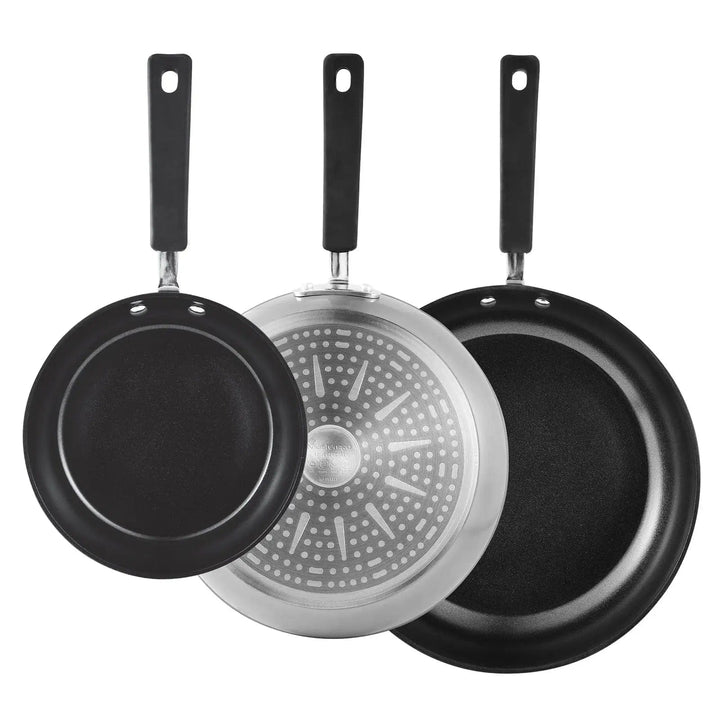 3 frying pans, one turned to show the dot induction base