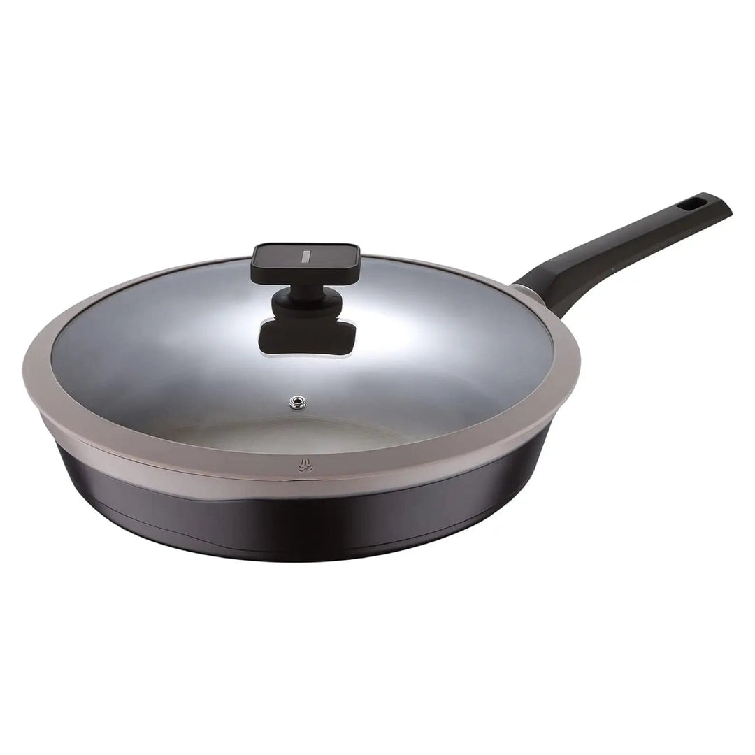 Light and dark brown frying pan with glass lid