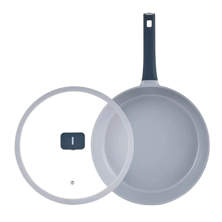 Top down view of a grey frying pan with glass lid