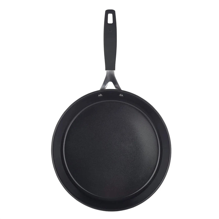 Overhead view of a large black frying pan with stay cool handle