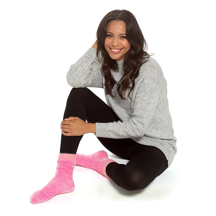 Female model wearing a pair of bright pink velvet socks