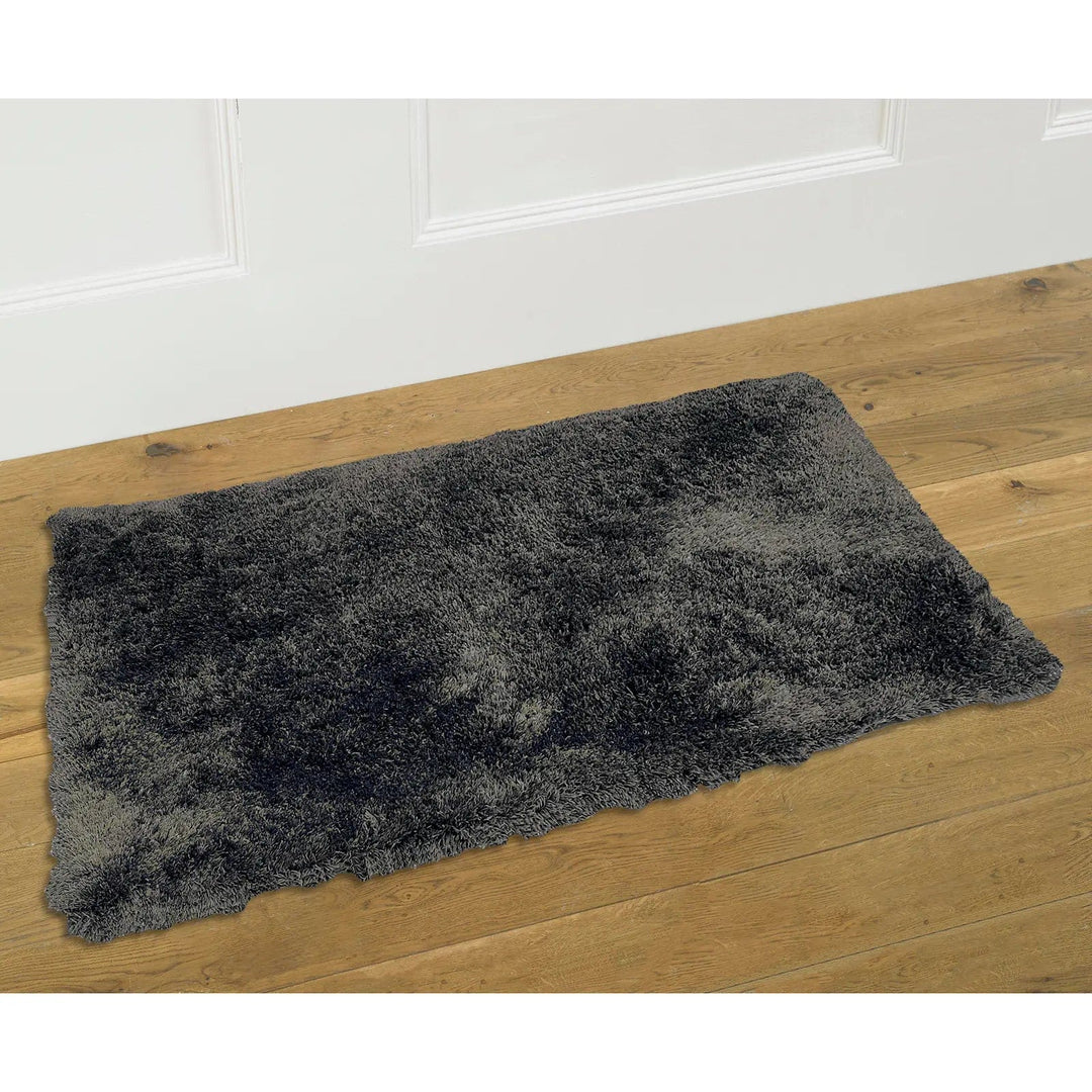 Warm grey teddy fleece rug on a wooden floor